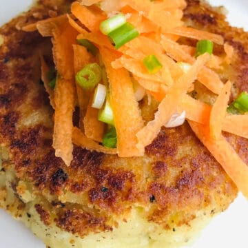 A round yam patty filled with shredded beef, topped with shredded beef