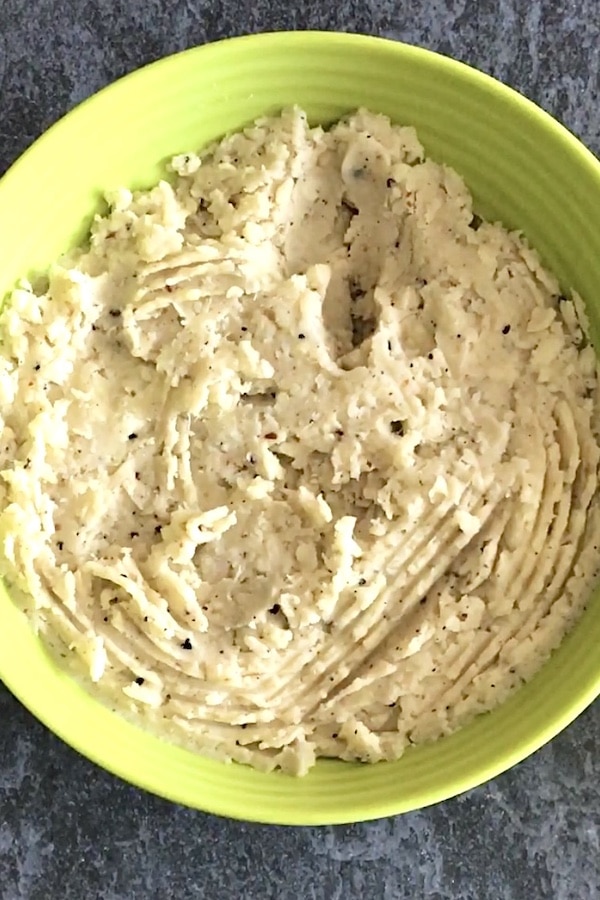 A round, rilled, lime green bowl with mash