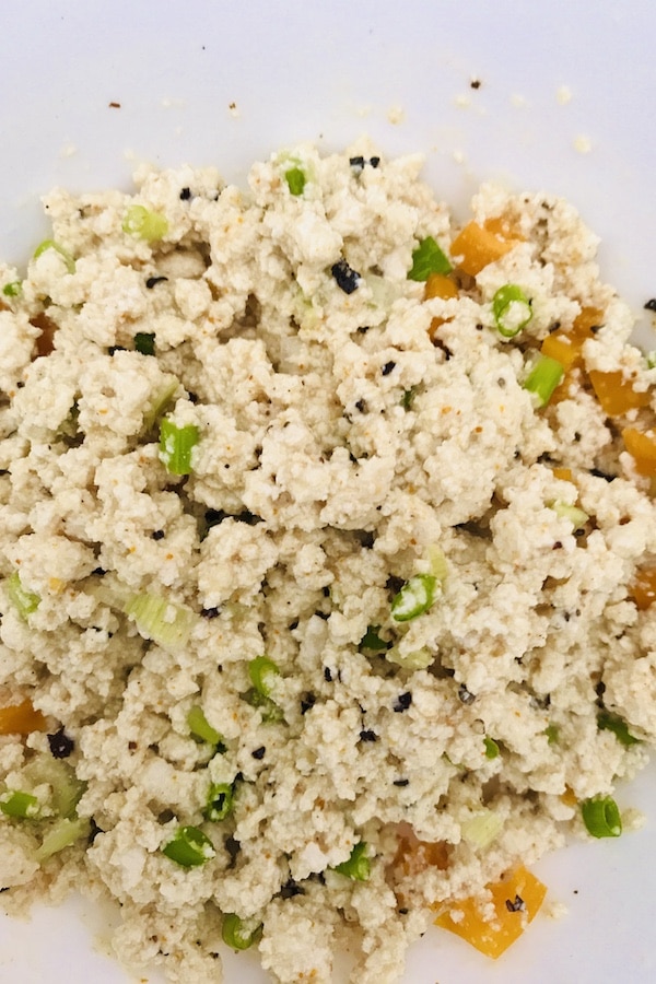 Tofu scramble mixed with spring onions, yellow bell pepper and spices