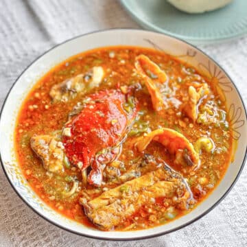Okro Soup in a shallow white bowl with a blue rim