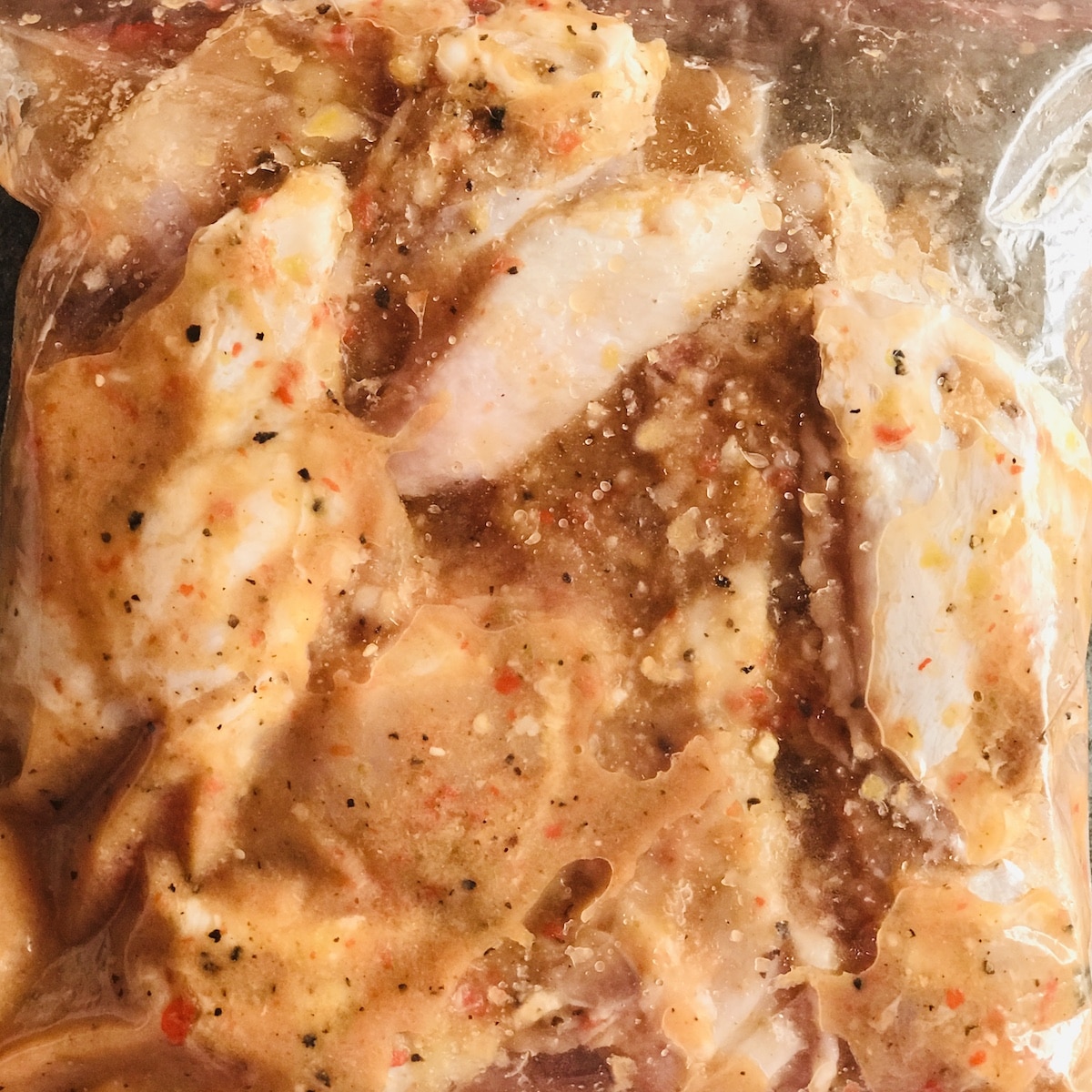 Chicken wings in a zip lock bag with marinade