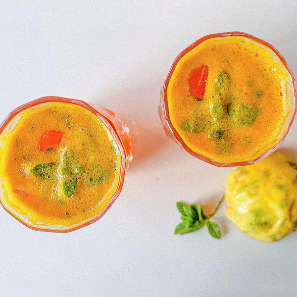 Overhead shot of 2 glasses with passion fruit and hibiscus cooler