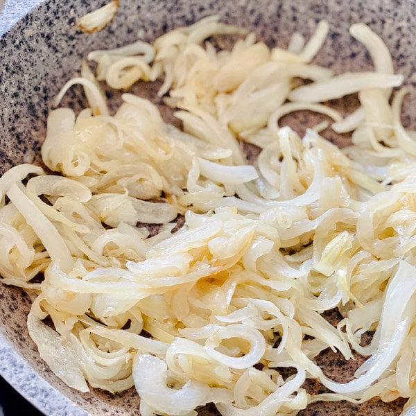 Soft fried onions in a bottled frying pan