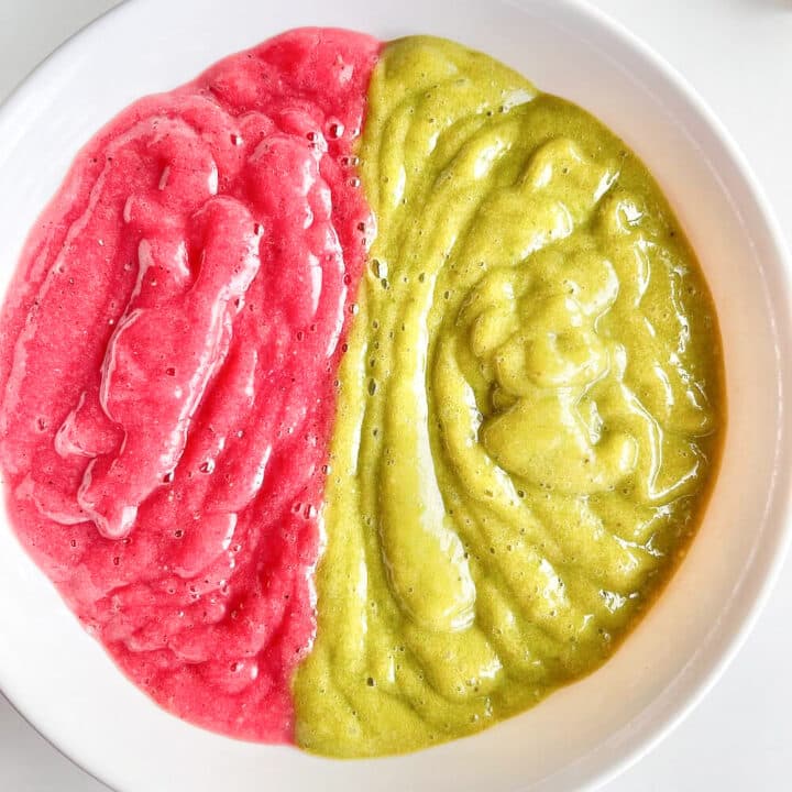 Smoothie bowl with half of the bowl red and the other half green.