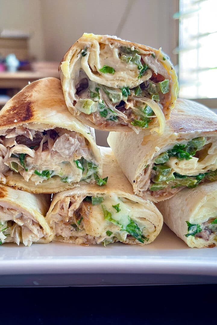 Cut chicken wraps stacked on top of each other.