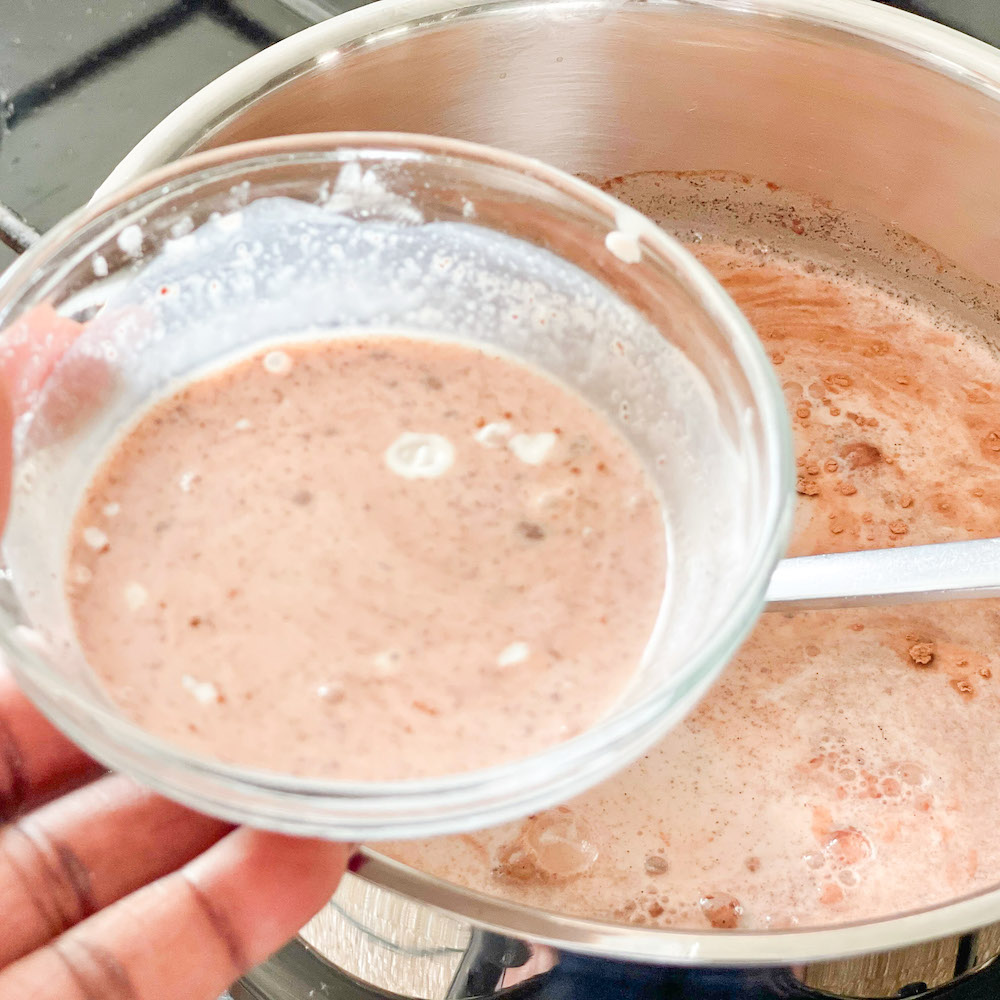Cornstarch, cocoa and milk mixture in a small glass bowl
