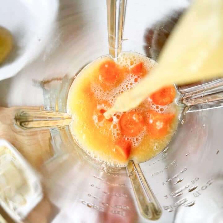 Orange juice and chopped carrots in a blender