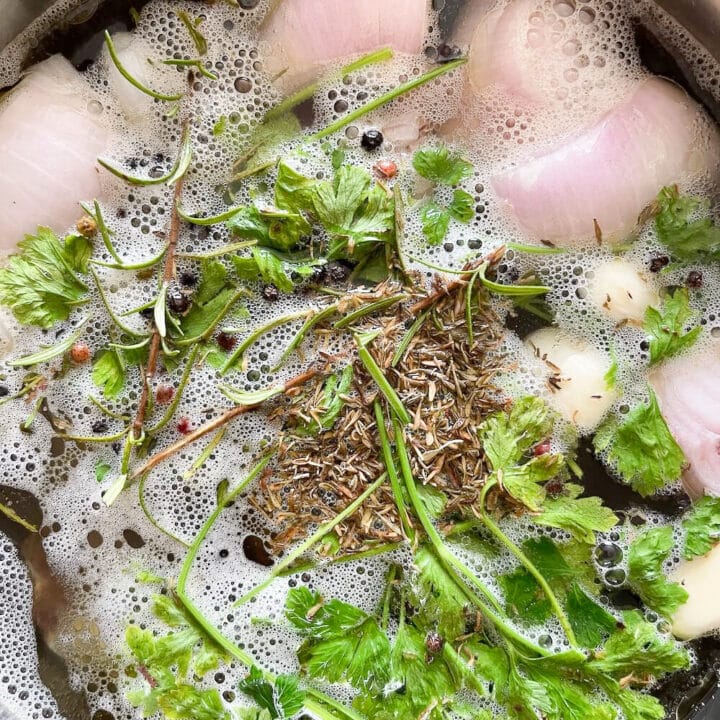 Onions, parsley, thyme in beef stock.