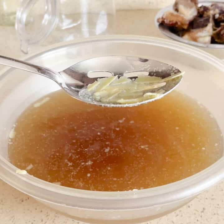 Scooping the fat from the beef stock