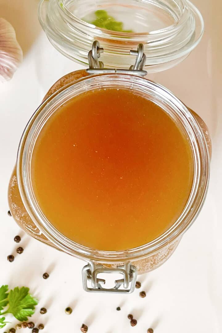 Beef stock in a large glass jar.