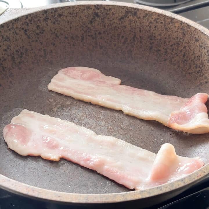Bacon frying in a pan.
