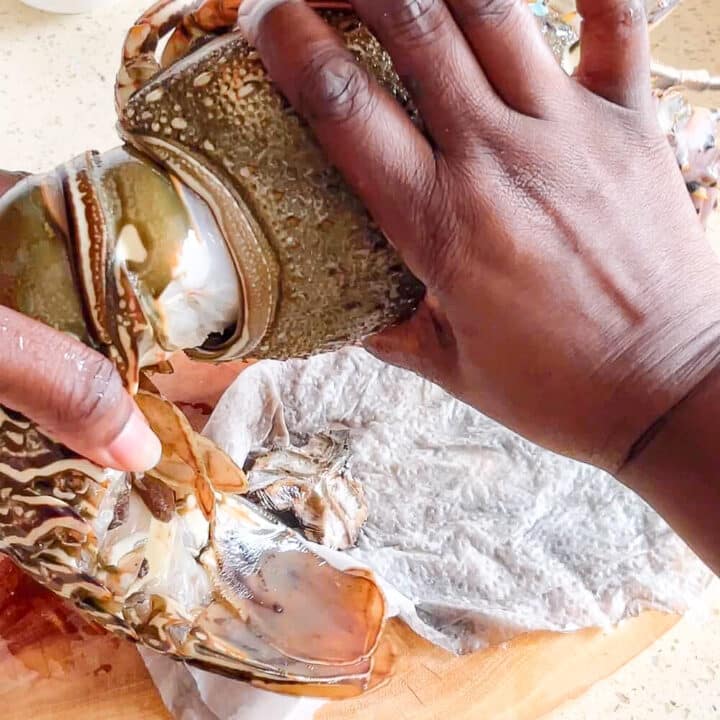 Lobster head being separated from the body.