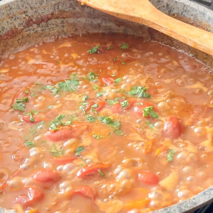 Chopped herbs in lobster sauce.