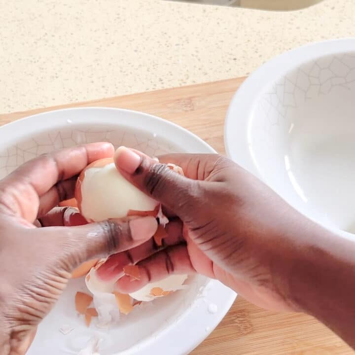 Peeling brown eggs.