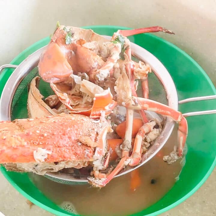 Lobster head and shells being sieved from the stock.