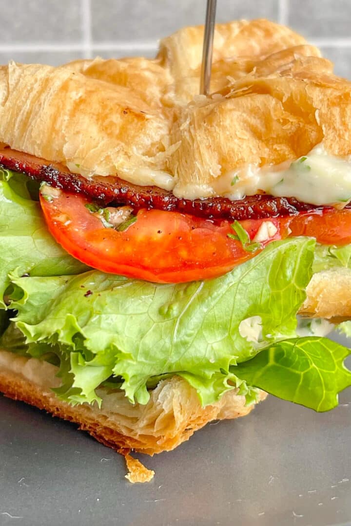Cut BLT croissant sandwich.
