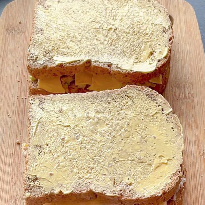 Buttered bread on a wooden board.